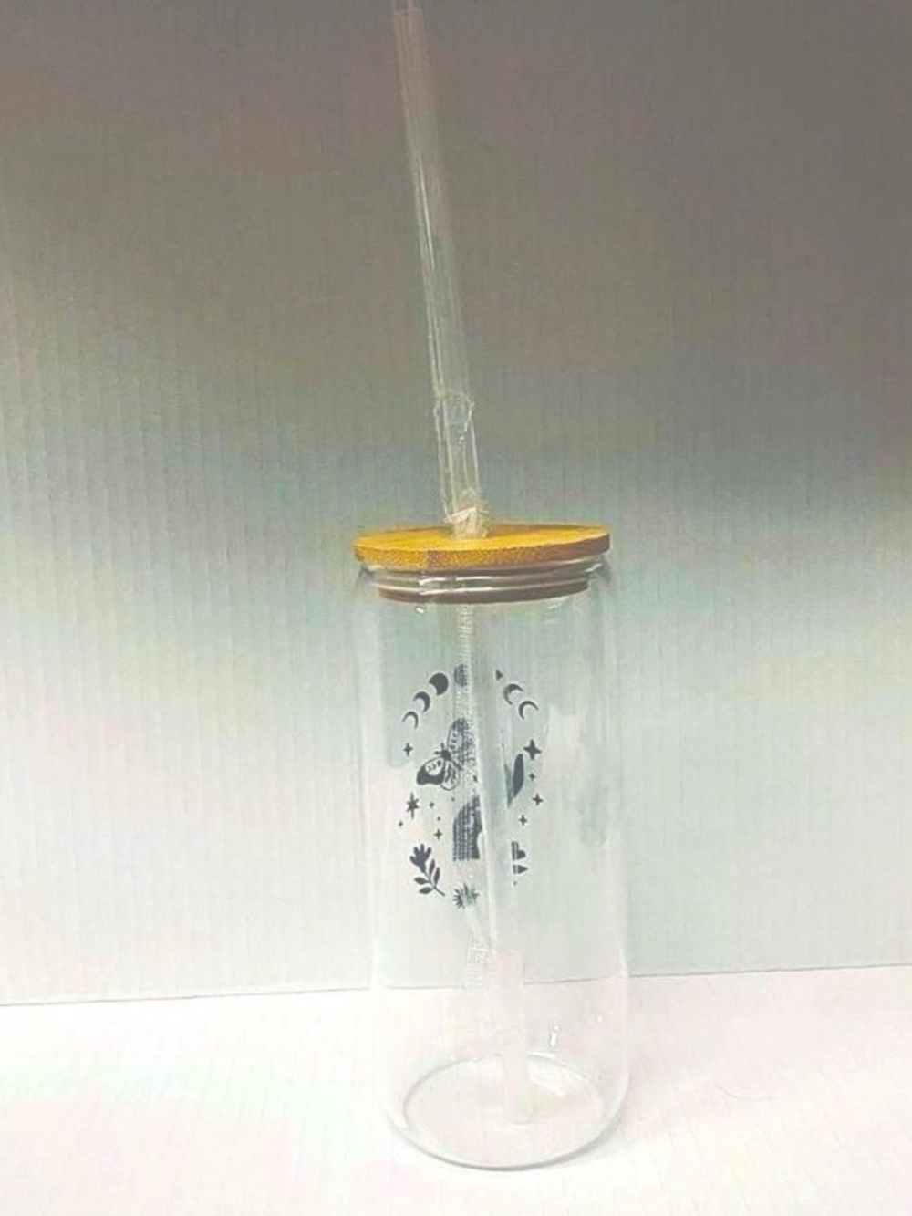 Glass 20 oz. tumbler with black moon phases and leaf design bamboo lid and glass